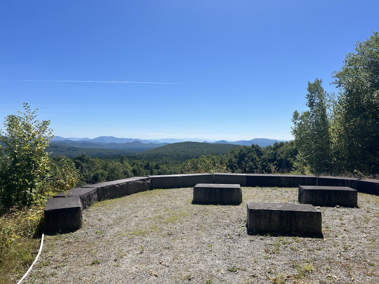 Vista of distant mountains from stone-edged viewing area.