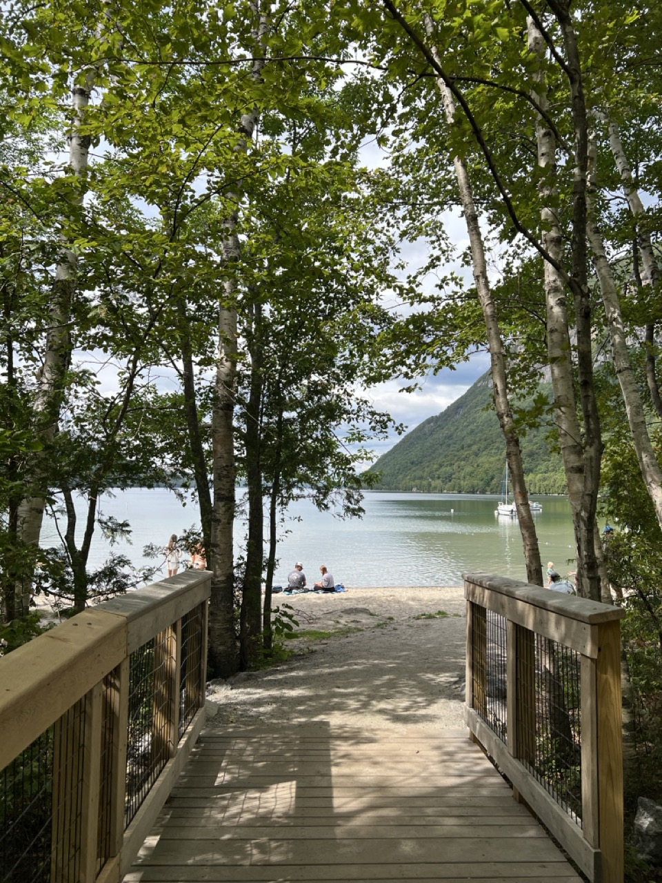 Wooden boardwalk leading to sandy beach overlooking Willoughby Lake.
